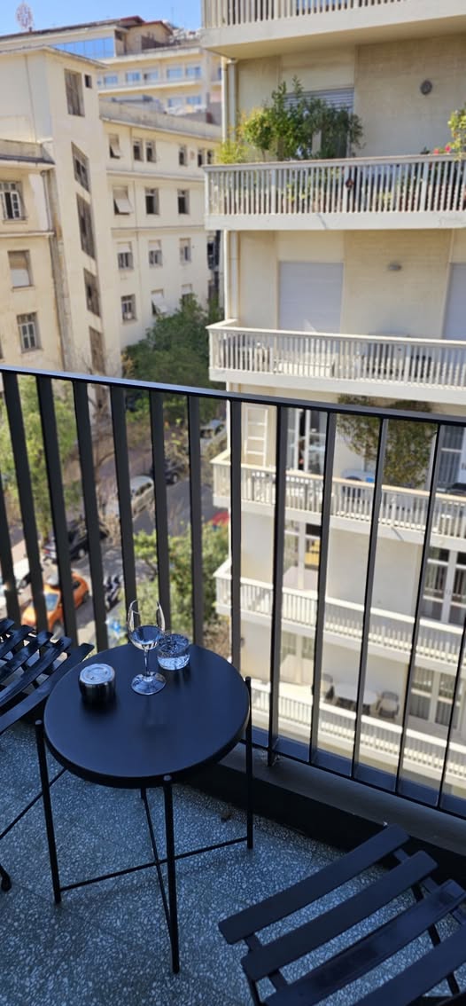 The view of a balcony at a hotel in Athens, Greece with two drinks and a place to sit and think